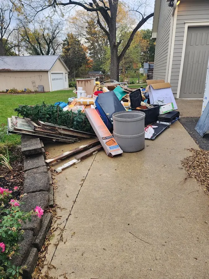 Dumpster being loaded with debris for Estate Cleanout Dumpster Rental in Horizon West